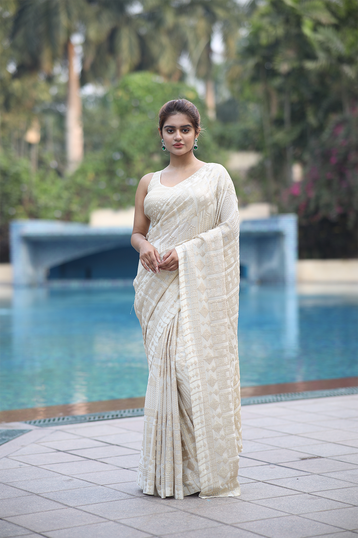Off-white georgette embroidered Saree with sleeveless blouse