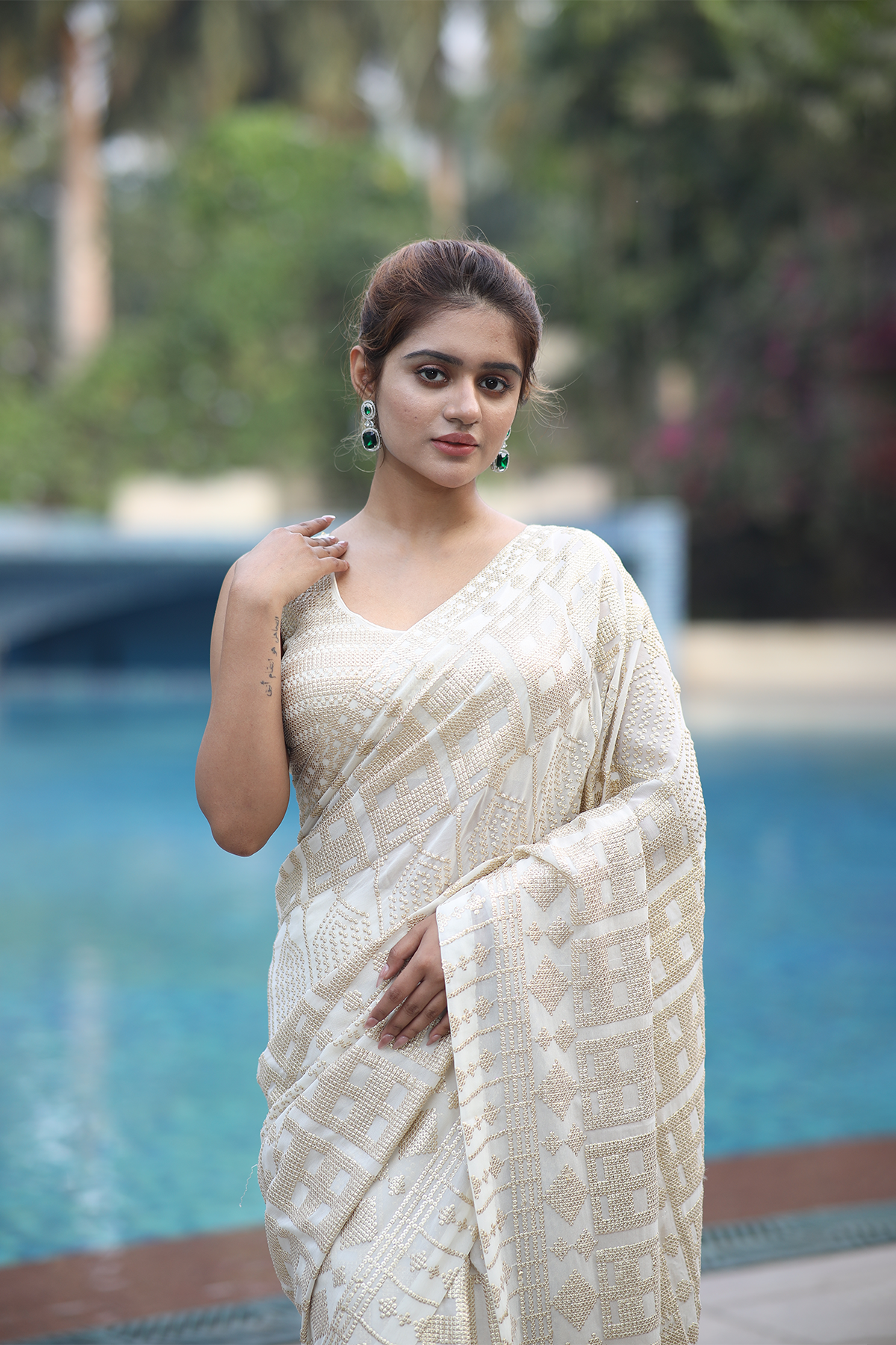 Off-white georgette embroidered Saree with sleeveless blouse