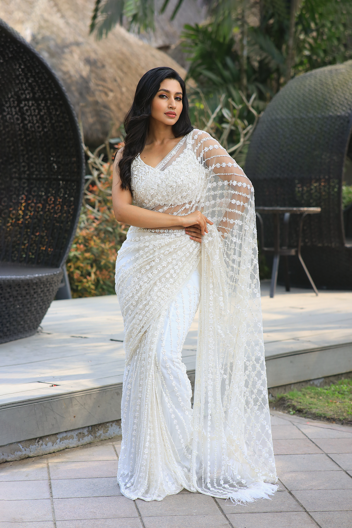 Off-white net embroidered Saree with sleeveless embroidered blouse