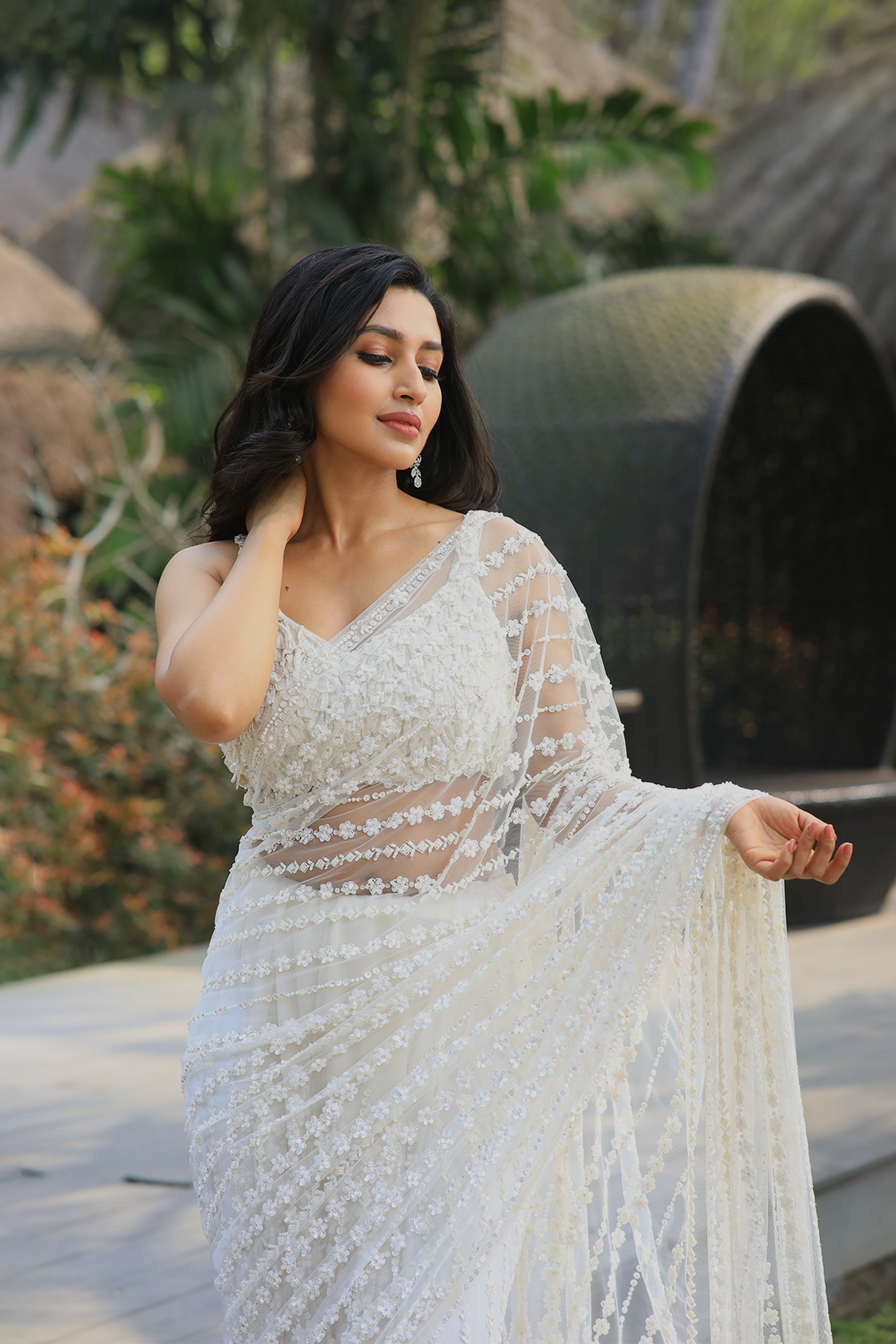 Off-white net embroidered Saree with sleeveless embroidered blouse