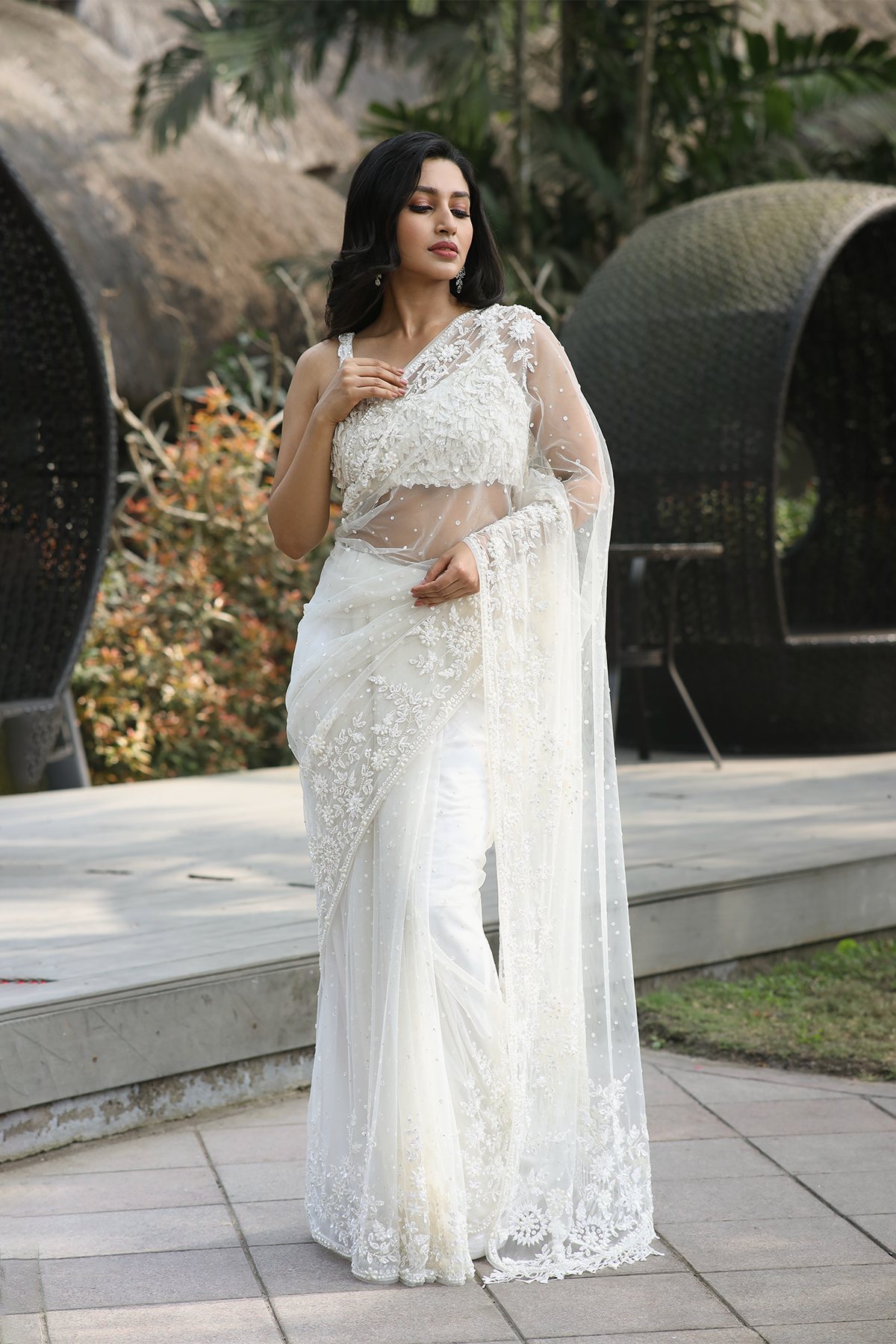 Off-white net embroidered Saree with statement sleeveless blouse