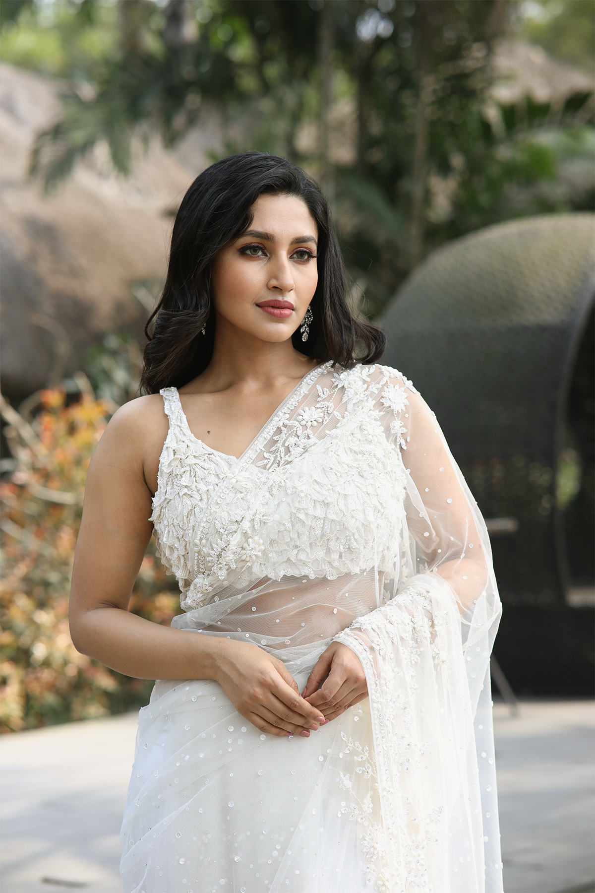 Off-white net embroidered Saree with statement sleeveless blouse