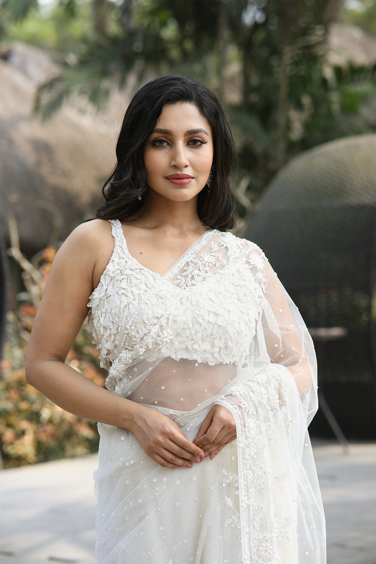 Off-white net embroidered Saree with statement sleeveless blouse