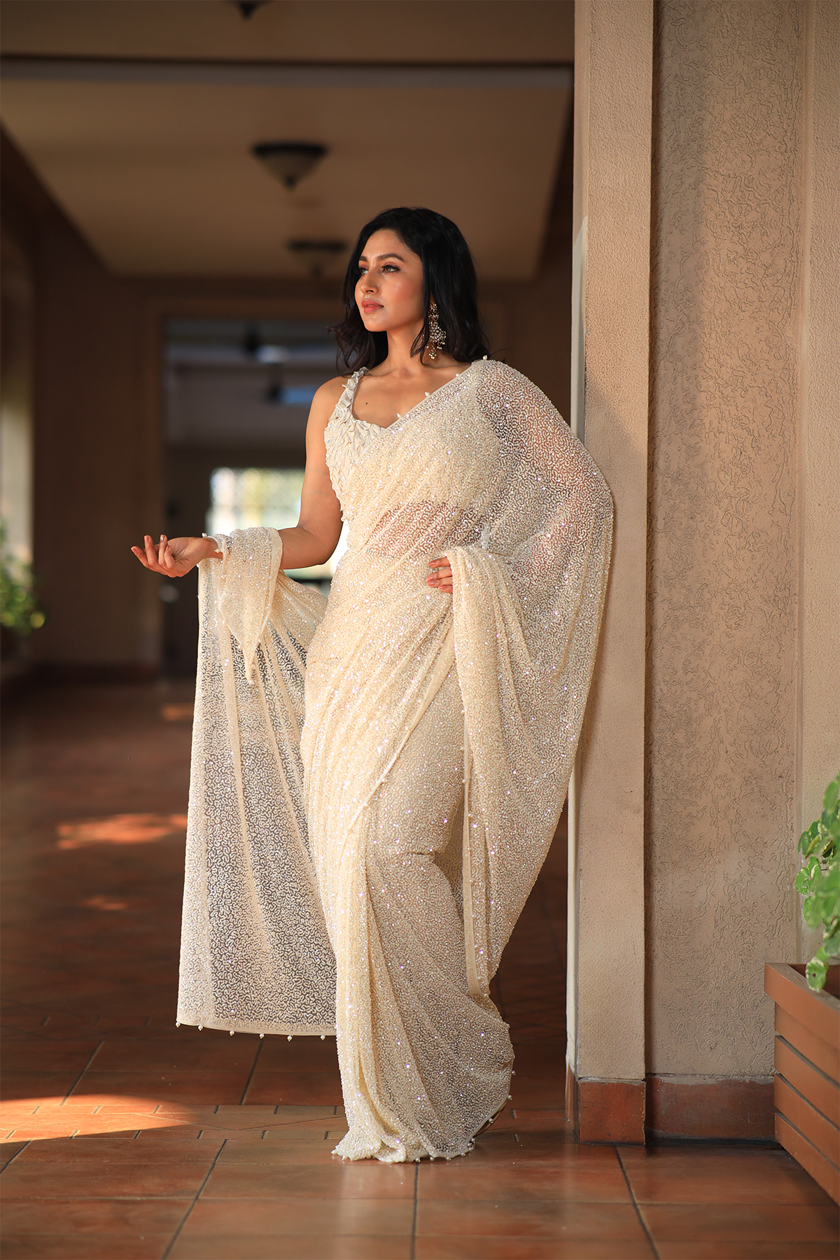Off white net embroidered Saree with statement sleeveless blouse