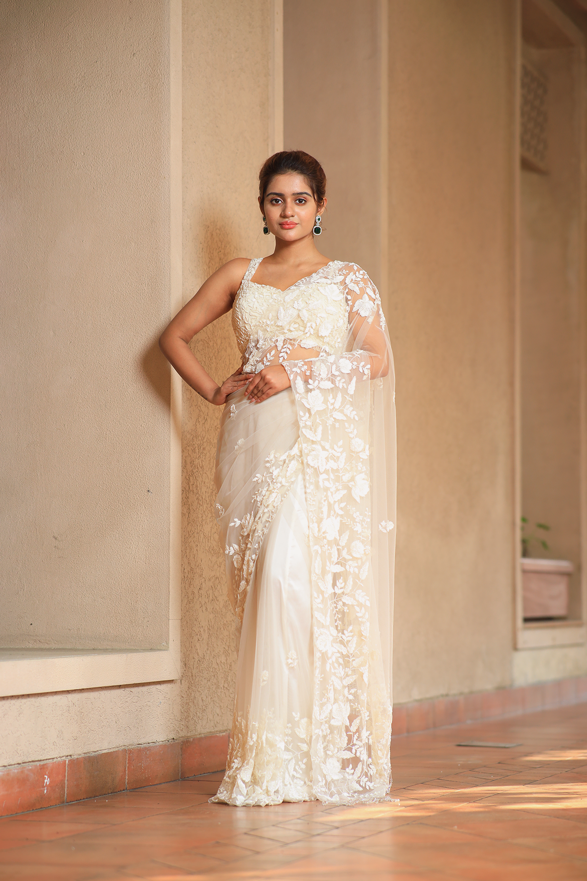Off-white net embroidered Saree with sleeveless blouse