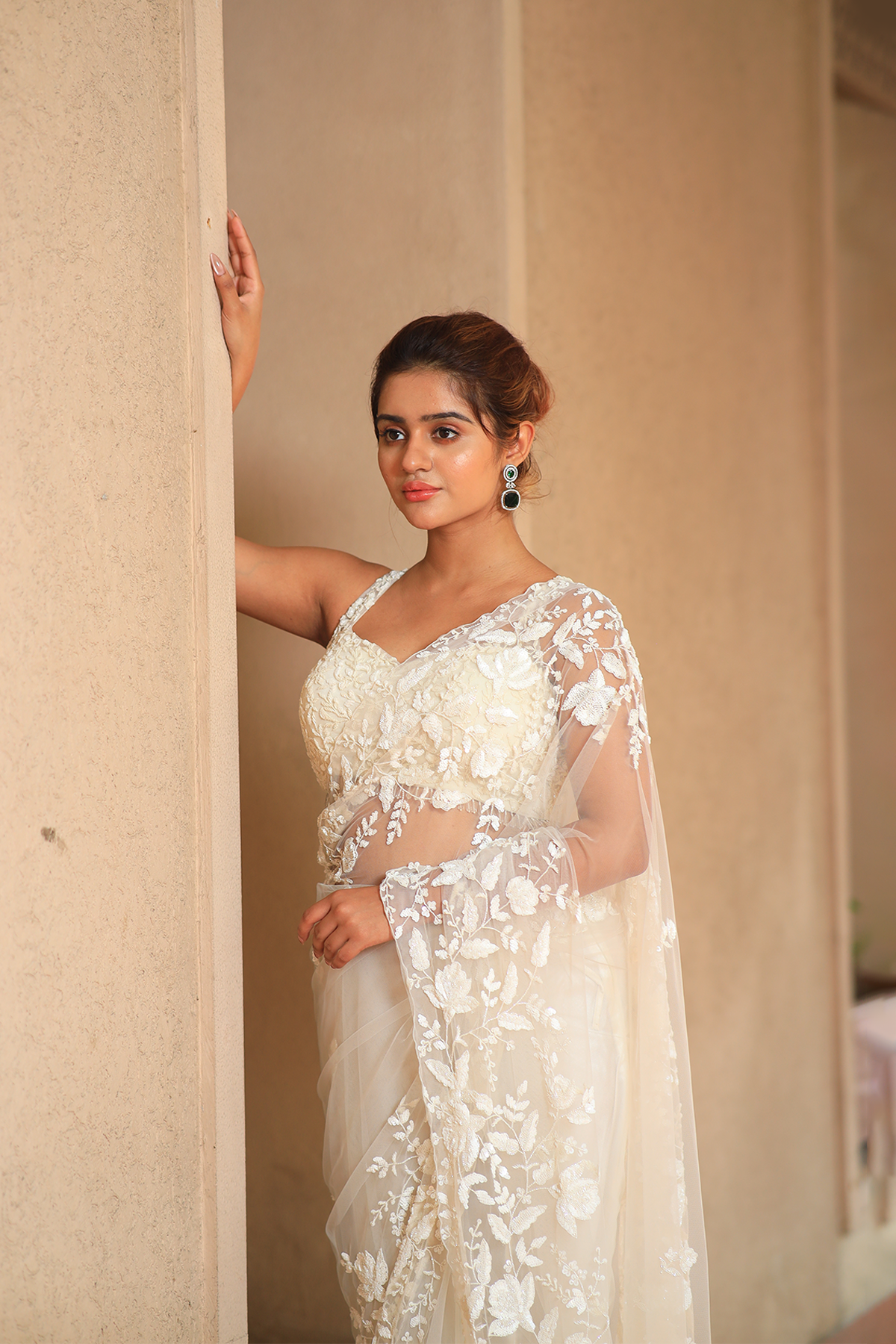Off-white net embroidered Saree with sleeveless blouse
