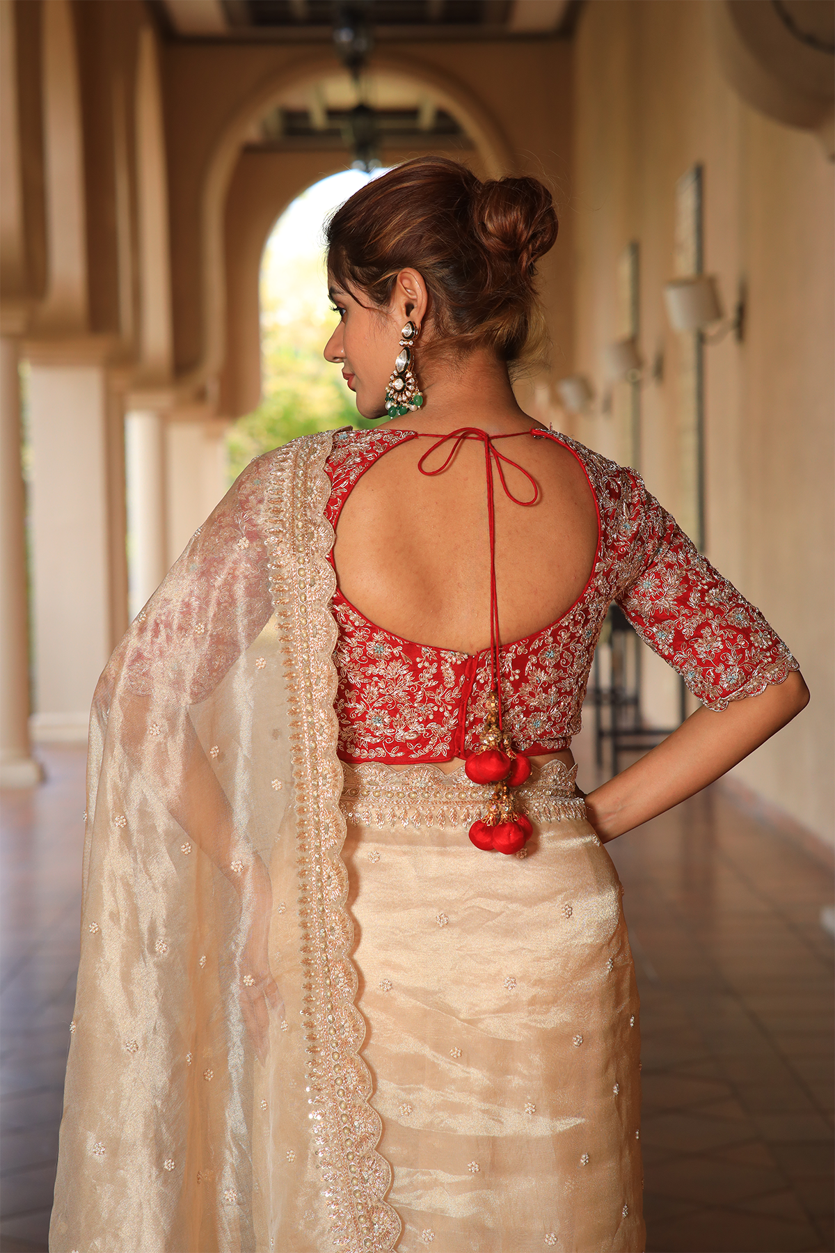 Gold hued tissue embroidered Saree with contrast elbow sleeve blouse