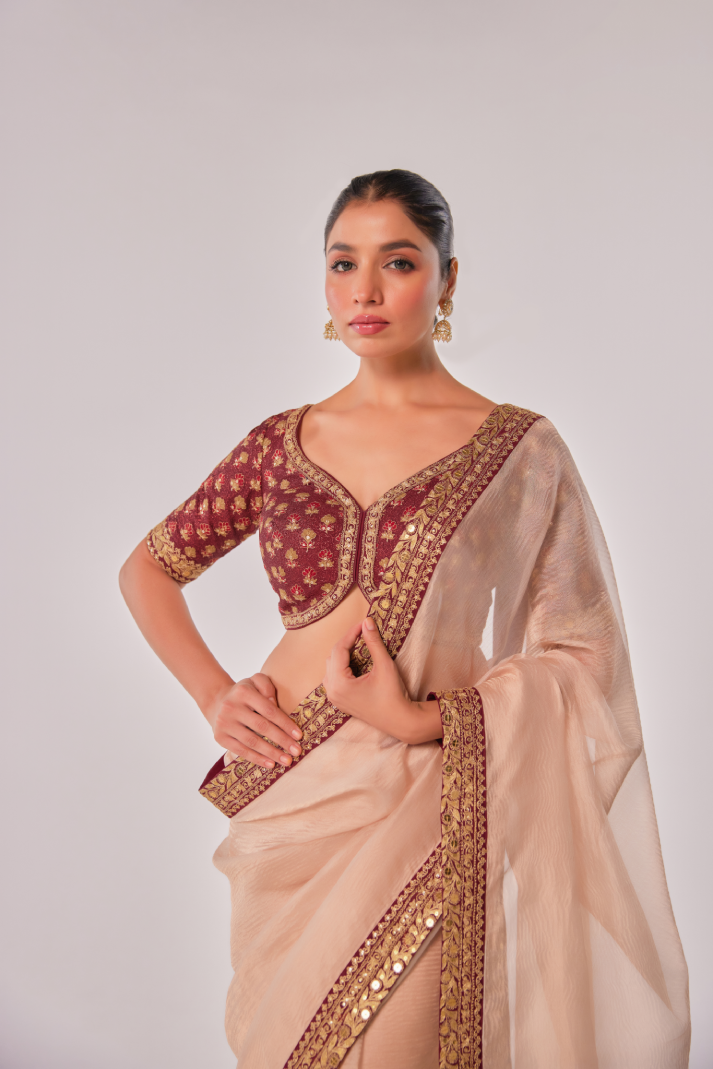 Gold hued peach crush tissue embroidered Saree with elbow sleeve blouse
