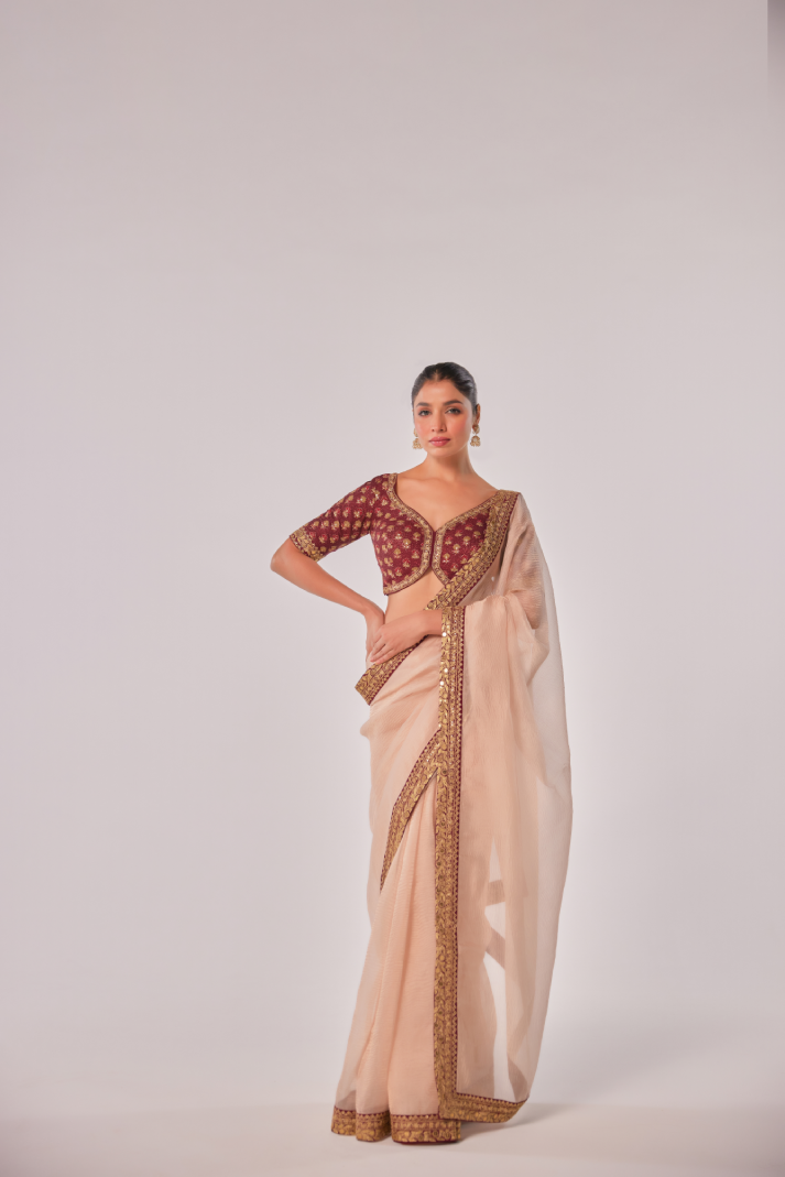 Gold hued peach crush tissue embroidered Saree with elbow sleeve blouse