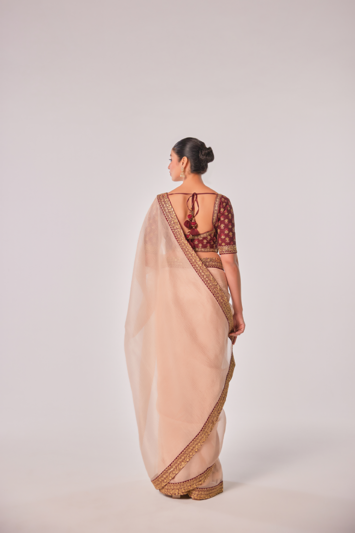Gold hued peach crush tissue embroidered Saree with elbow sleeve blouse