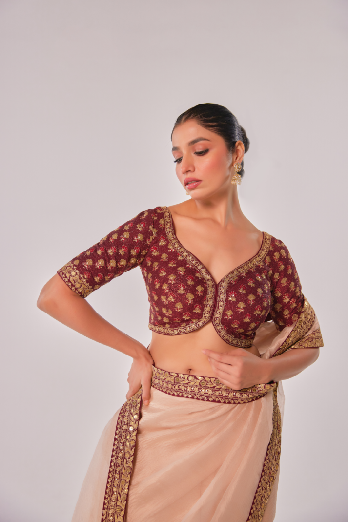 Gold hued peach crush tissue embroidered Saree with elbow sleeve blouse