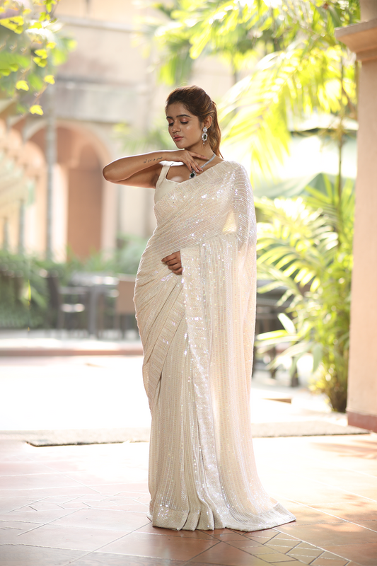 Off-white georgette embroidered Saree with sleeveless raw silk blouse
