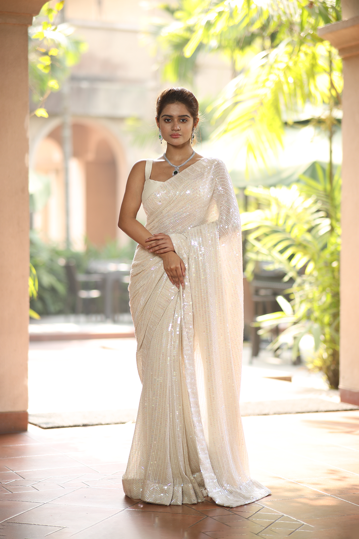 Off-white georgette embroidered Saree with sleeveless raw silk blouse