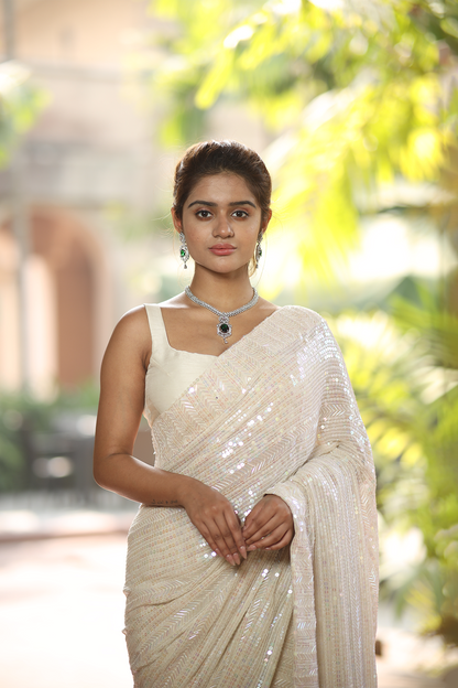 Off-white georgette embroidered Saree with sleeveless raw silk blouse