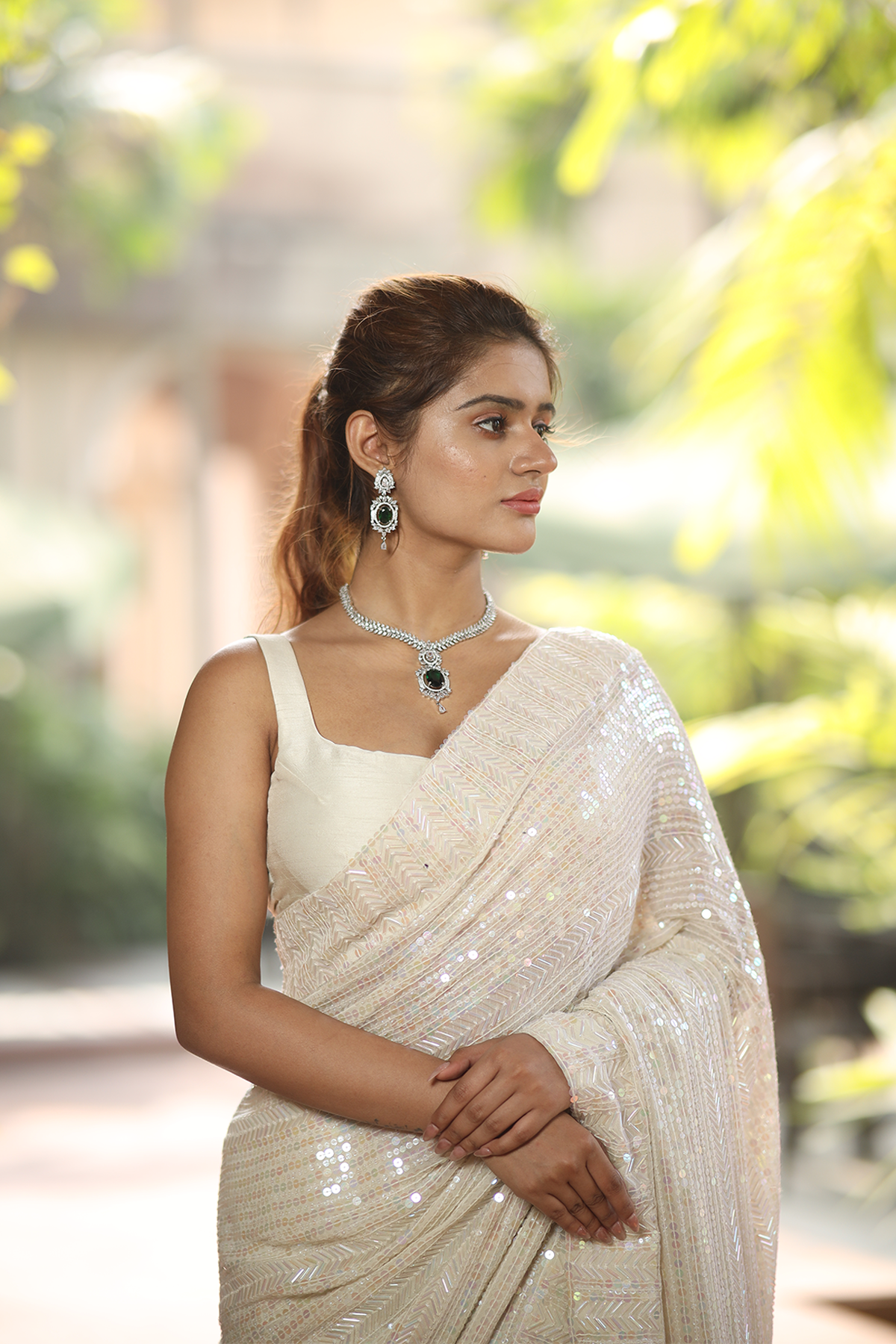 Off-white georgette embroidered Saree with sleeveless raw silk blouse