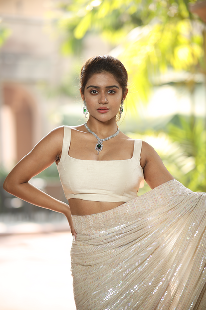 Off-white georgette embroidered Saree with sleeveless raw silk blouse