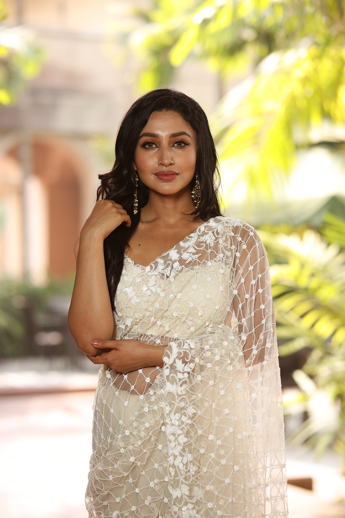 Off-white net embroidered Saree with sleeveless embroidered blouse