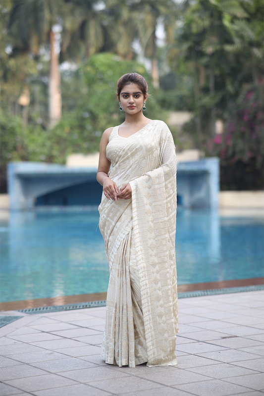 Off-white georgette embroidered Saree with sleeveless blouse