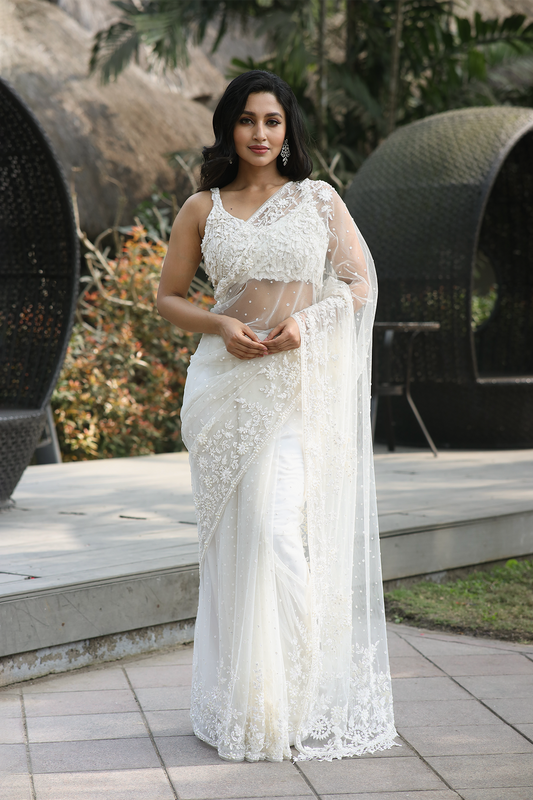 Off-white net embroidered Saree with statement sleeveless blouse
