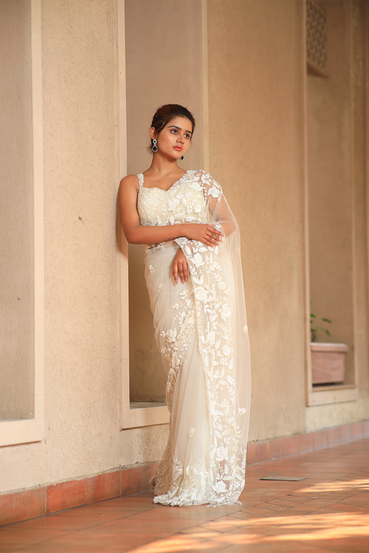Off-white net embroidered Saree with sleeveless blouse