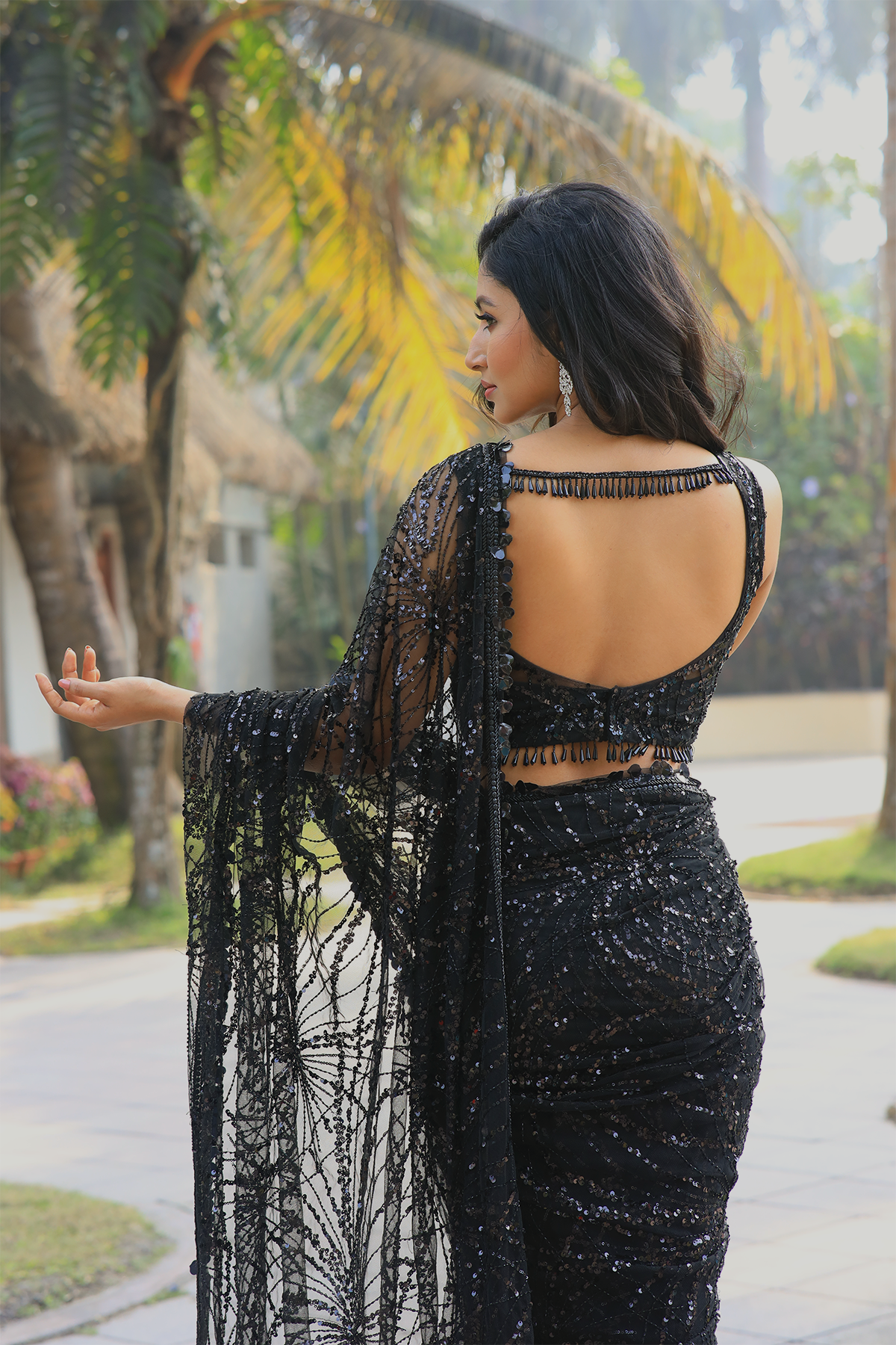 Black net embroidered Saree with sleeveless embroidered blouse