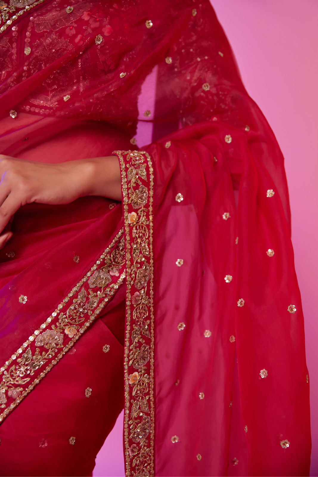 Rani pink organza embroidered Saree with multi-color elbow sleeve blouse