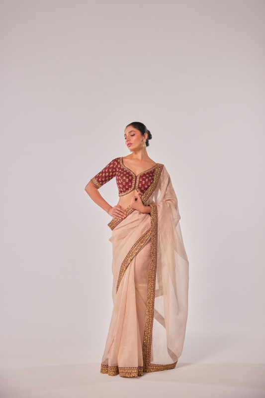 Gold hued peach crush tissue embroidered Saree with elbow sleeve blouse