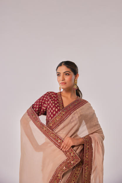 Gold hued peach crush tissue embroidered Saree with elbow sleeve blouse