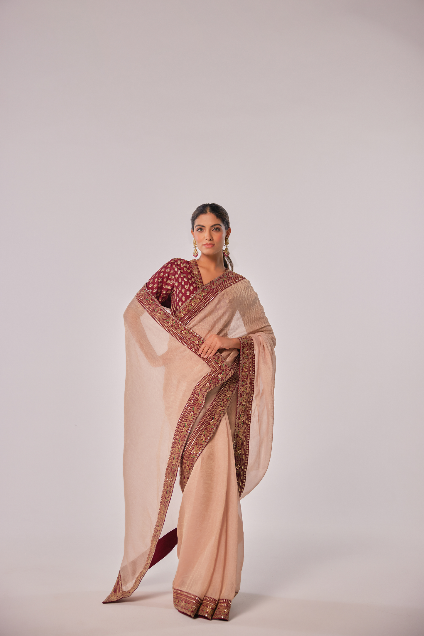 Gold hued peach crush tissue embroidered Saree with elbow sleeve blouse