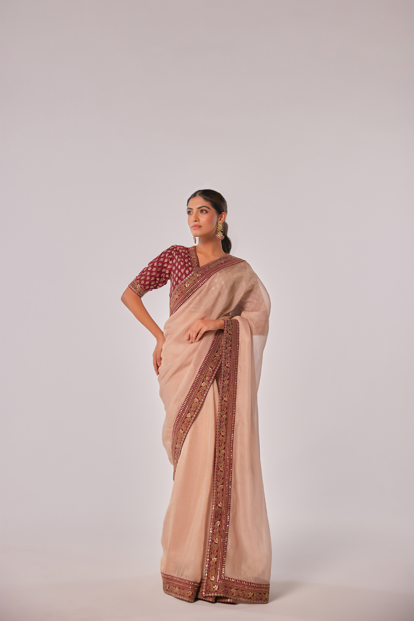 Gold hued peach crush tissue embroidered Saree with elbow sleeve blouse