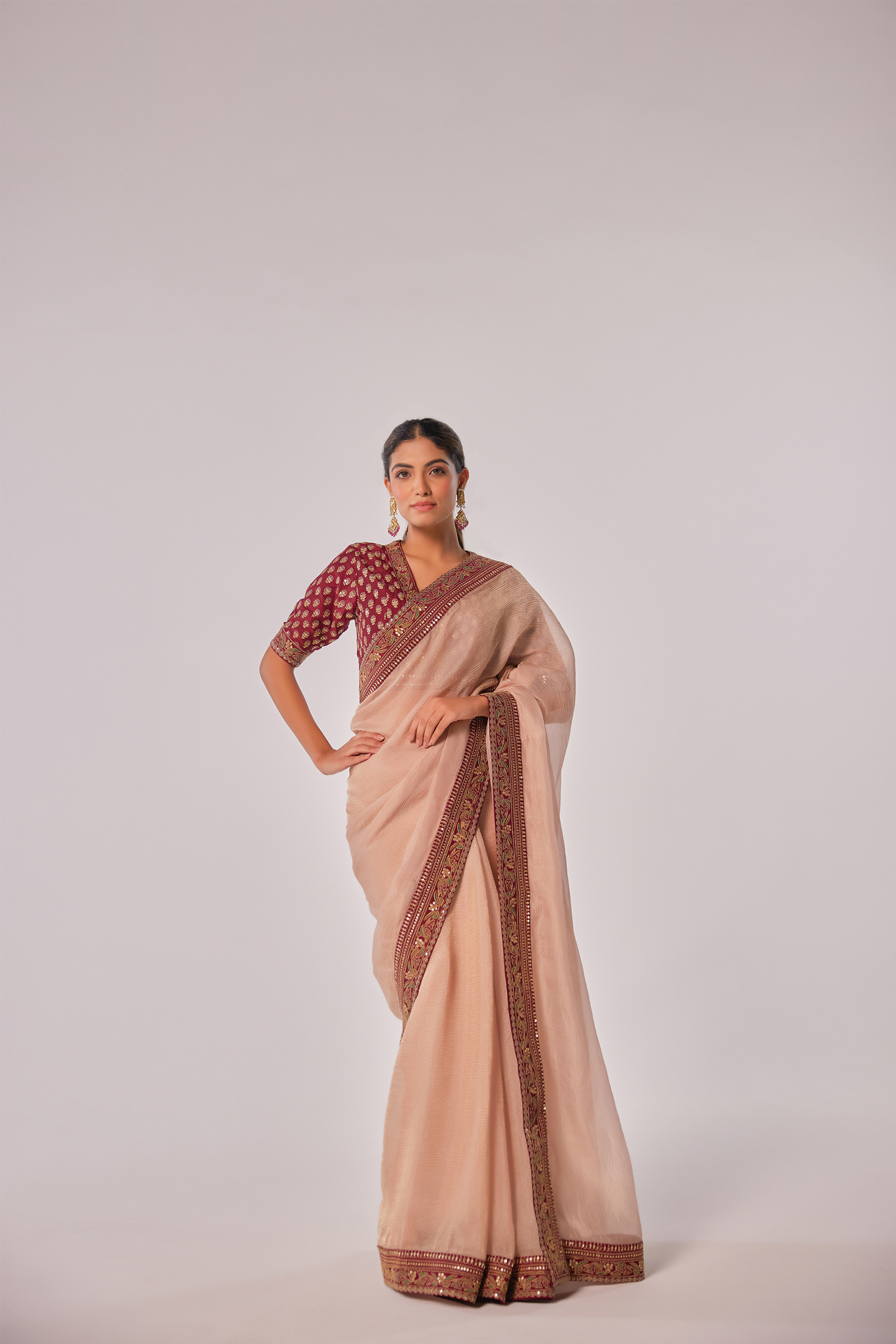 Gold hued peach crush tissue embroidered Saree with elbow sleeve blouse