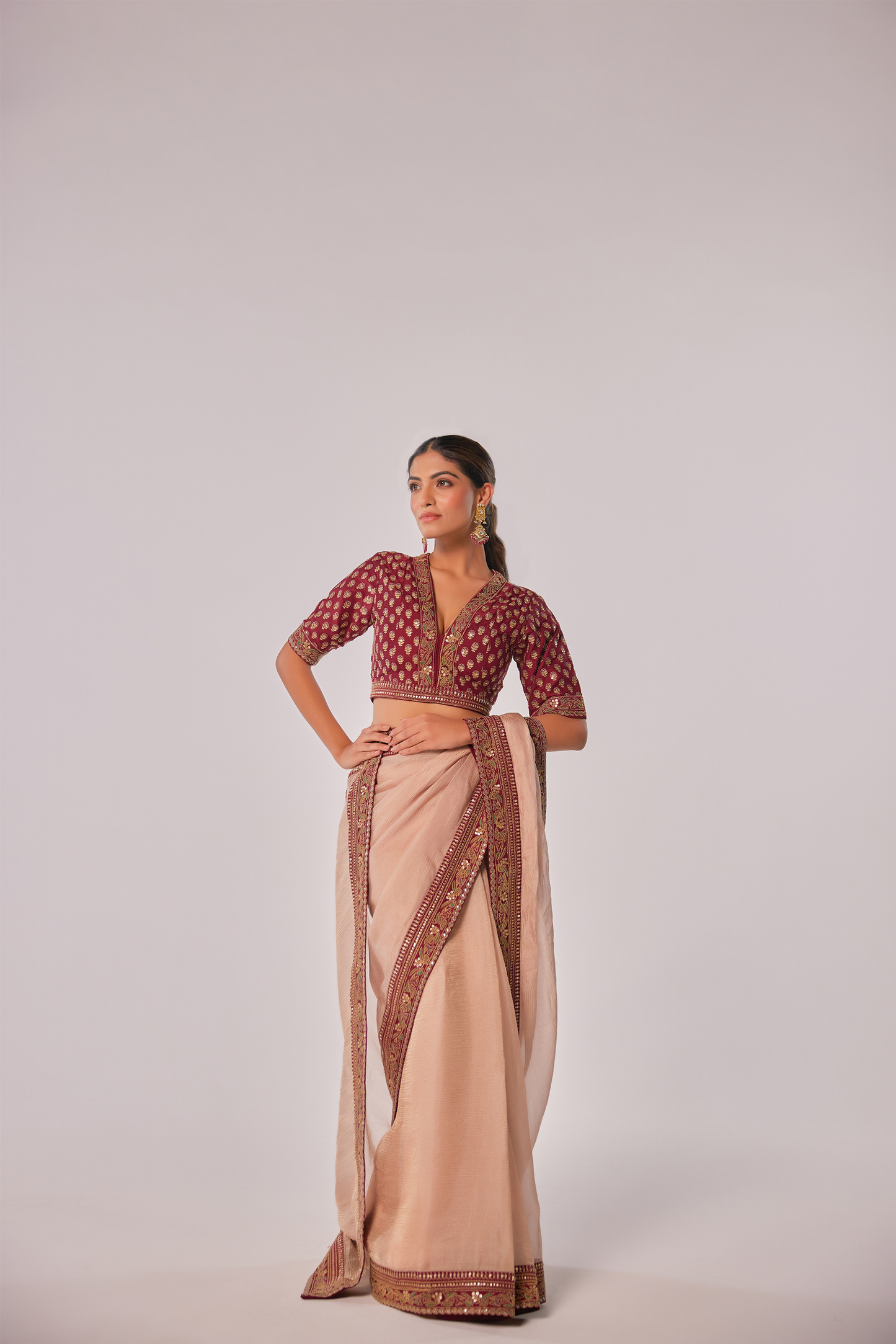 Gold hued peach crush tissue embroidered Saree with elbow sleeve blouse